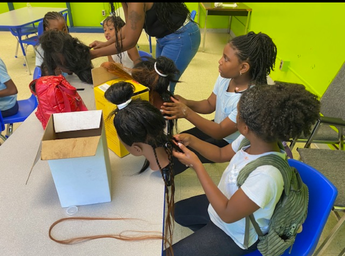 A class where young people are being taught how to do hair